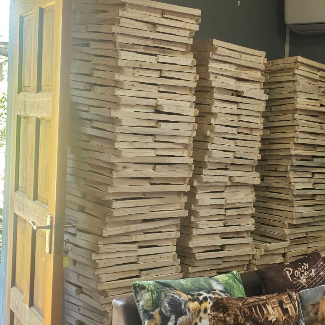 A stack of wooden honey super frames from Ricky's Bees & Honey.